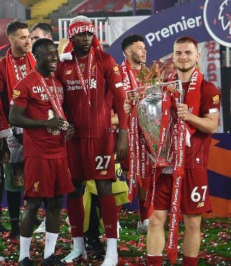 Harvey Elliott posing with the Premier League cup.